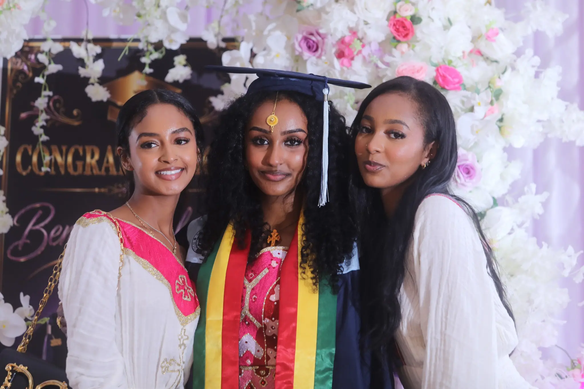Graduate posing with two friends